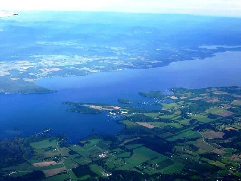 An aerial view of a large body of water surrounded by fields.