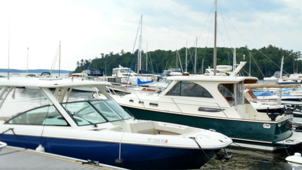 A group of boats are docked at a marina.
