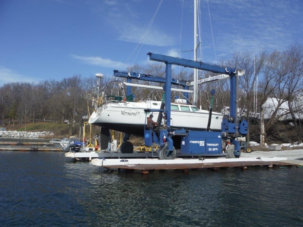 A boat is being lifted into the water by a crane