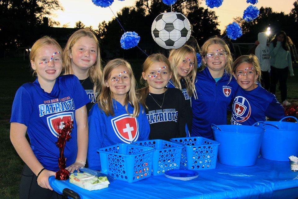 a group of girls wearing patriotic shirts are posing for a picture