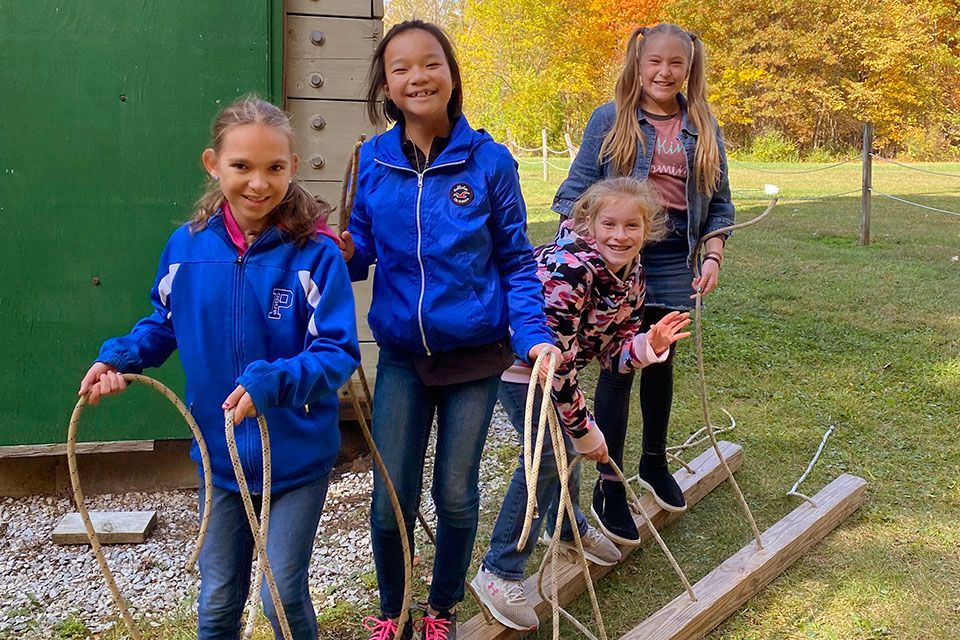 a girl wearing a blue jacket with the letter p on it
