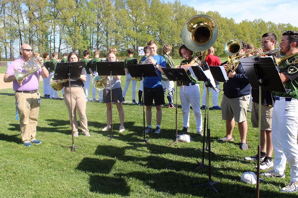 A band ensemble plays the National Anthem