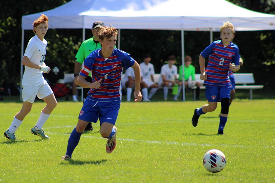 An ODCS boys varsity soccer team member pursues the ball