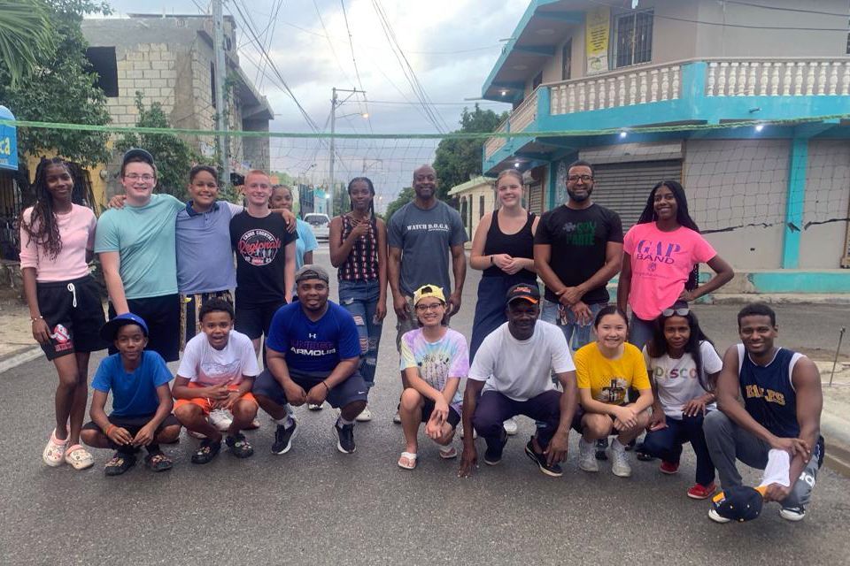 Students, leaders, and citizens posing for a picture on the street.