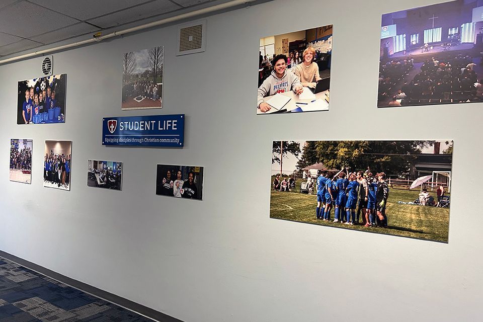 A photographic wall display of student life at ODCS