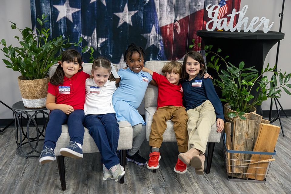 A group of young students pose for a picture on Veteran's Day.