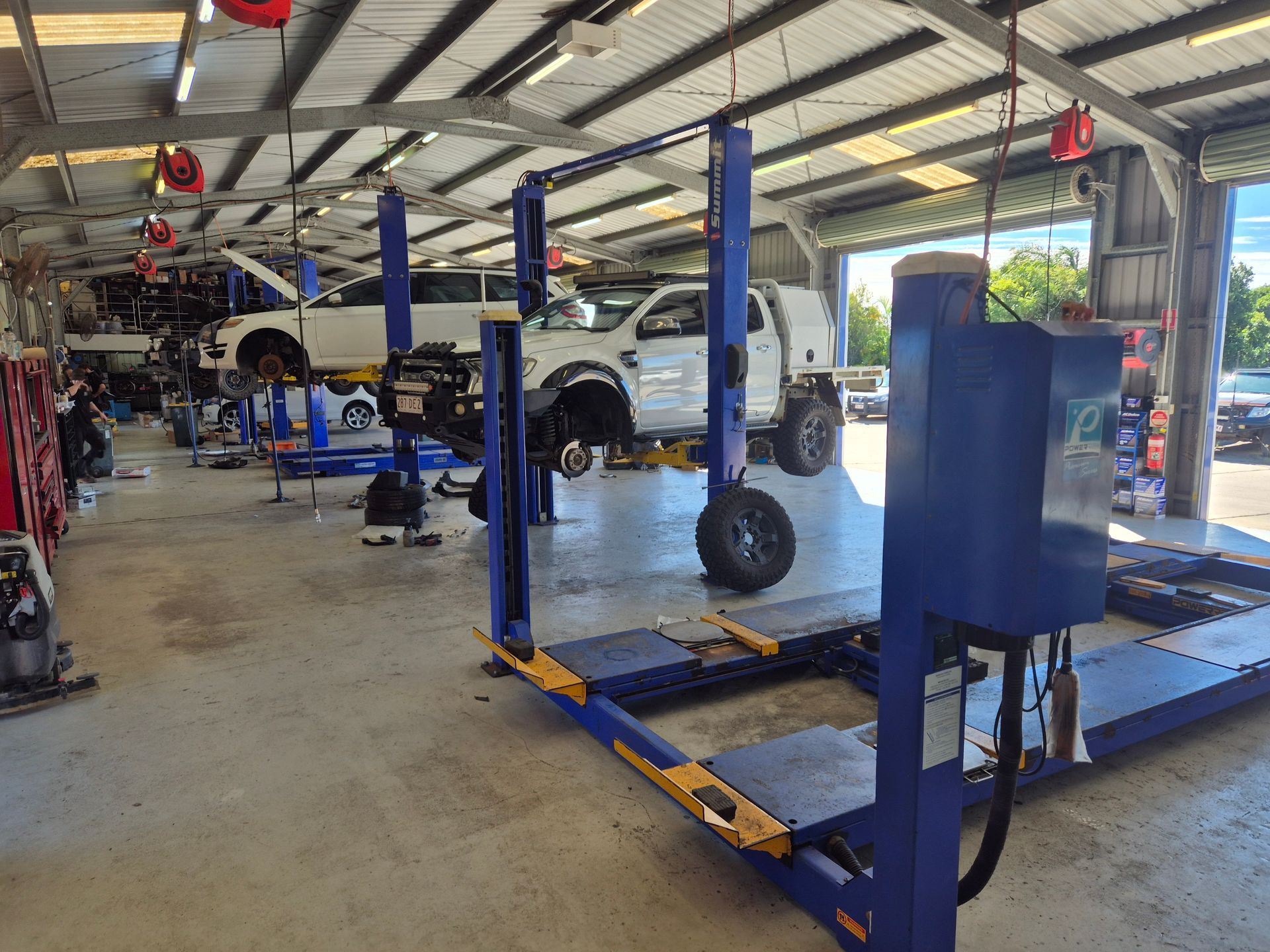Two Cars on Lifts in an Auto Repair Shop — Emu Park Automotive and Tyre Service in Keppel Sands, QLD