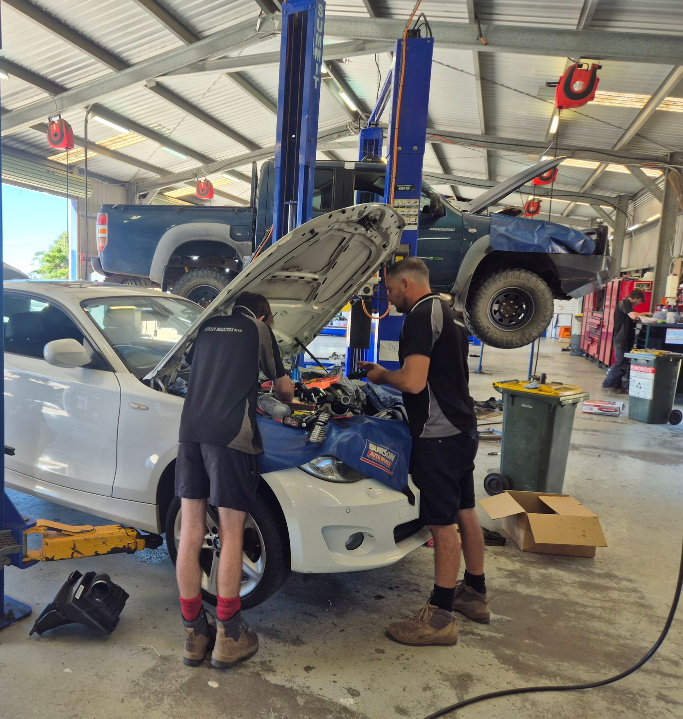 Two Mechanics Working on a White Car — Emu Park Automotive and Tyre Service in Zilzie, QLD