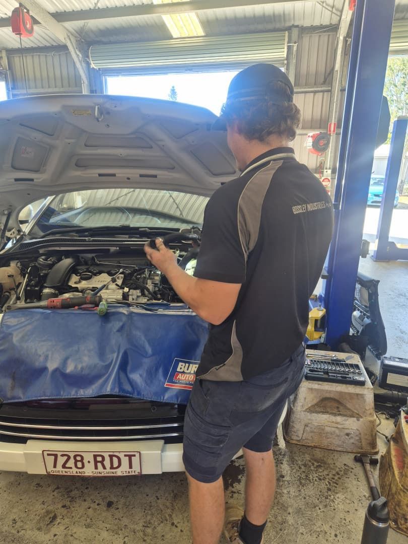 Mechanic Inspecting an Open Car Hood in a Garage — Emu Park Automotive and Tyre Service in Yeppoon, QLD