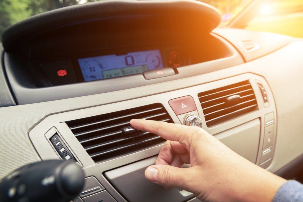 A Person Is Adjusting the Air Conditioner in A Car — Emu Park Automotive and Tyre Service in Emu Park, QLD