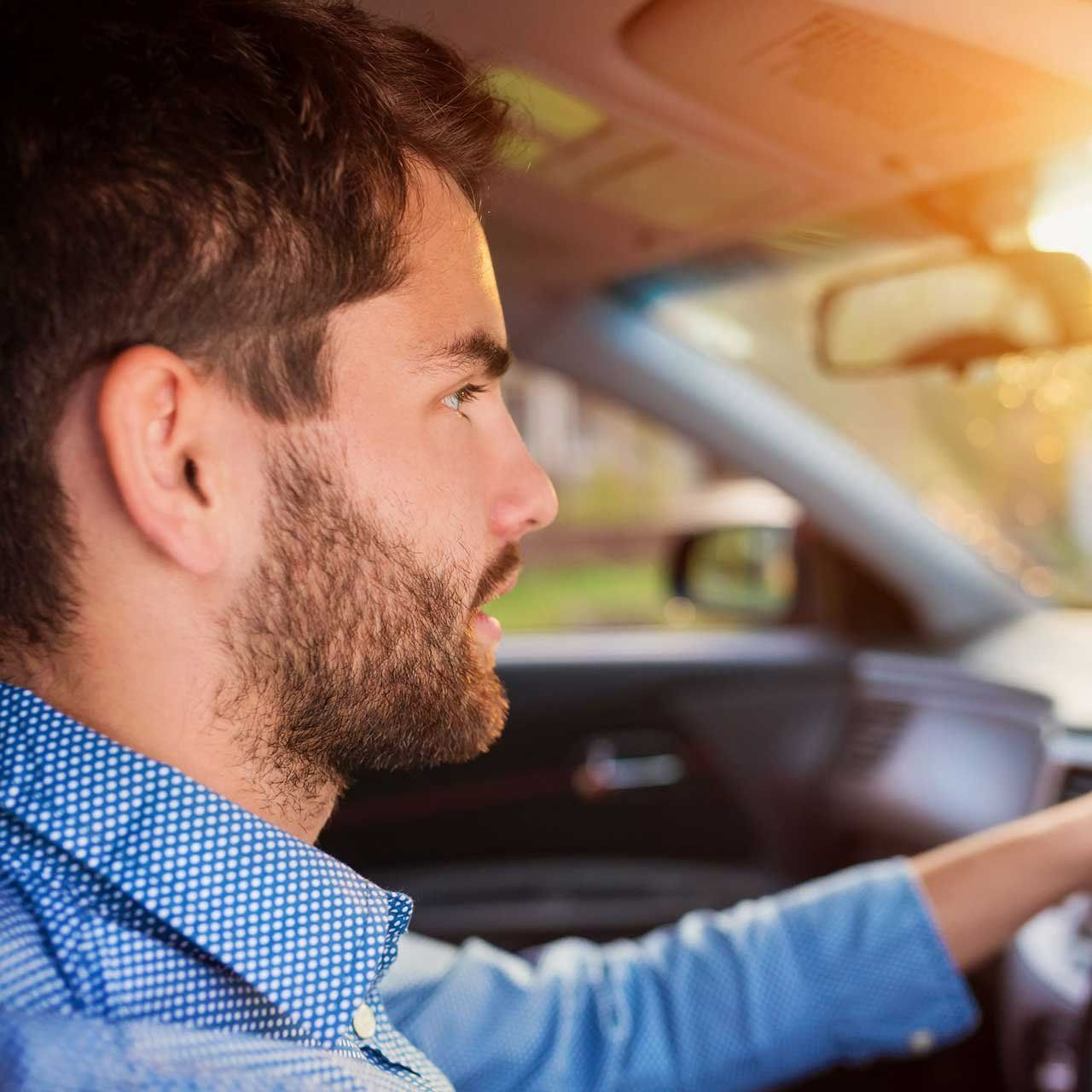 A Man with A Beard Is Driving a Car — Emu Park Automotive and Tyre Service in Emu Park, QLD