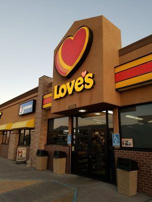 Love's gas station exterior. Red heart logo above entrance, tan and brick building. Accessibility features visible.