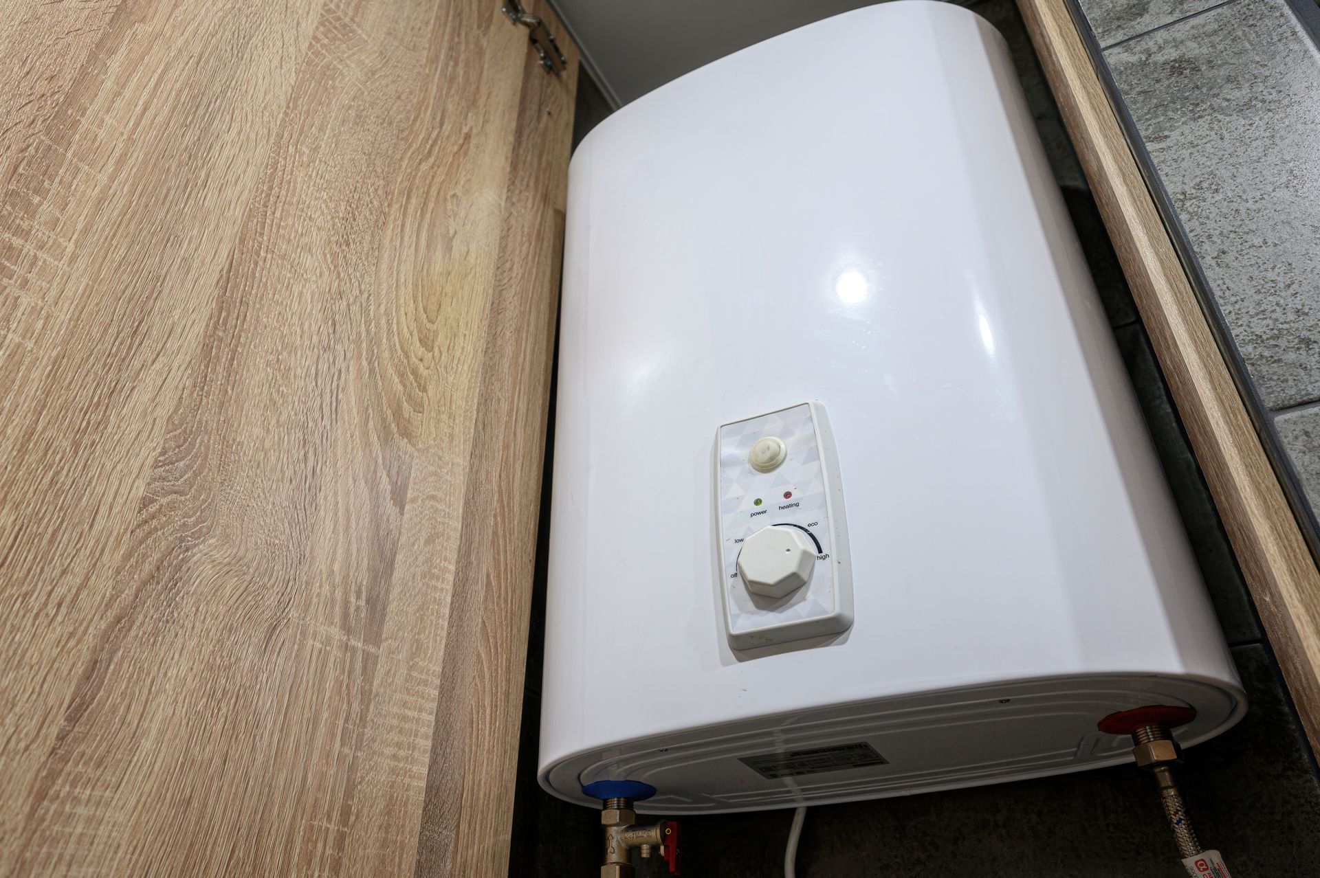 Licensed plumber performing gas water heater repair in a Garland, TX home