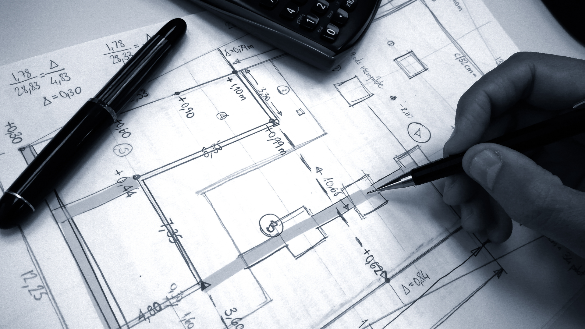 A person is drawing on a piece of paper with a pen