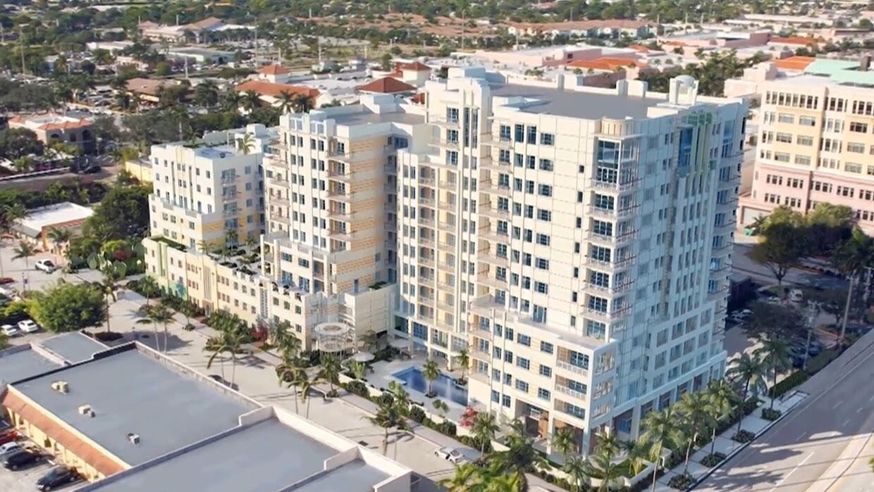 An aerial view of a large apartment building in a city.