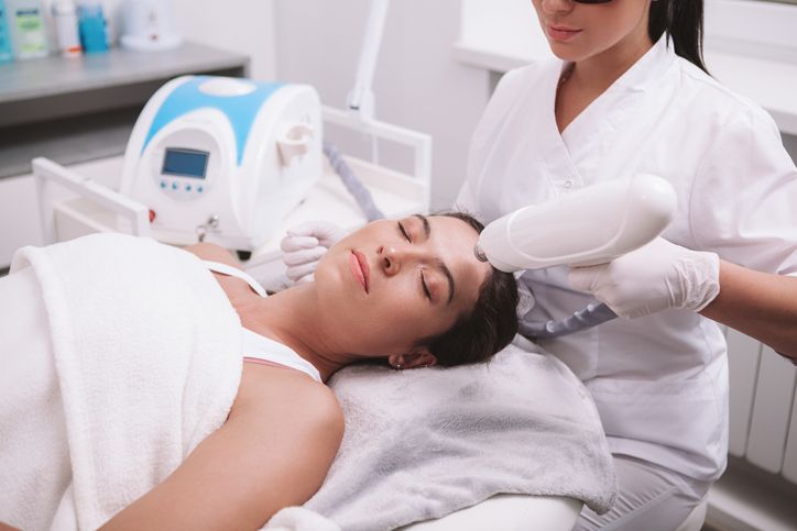 Beautiful woman getting skincare treatment at beauty salon