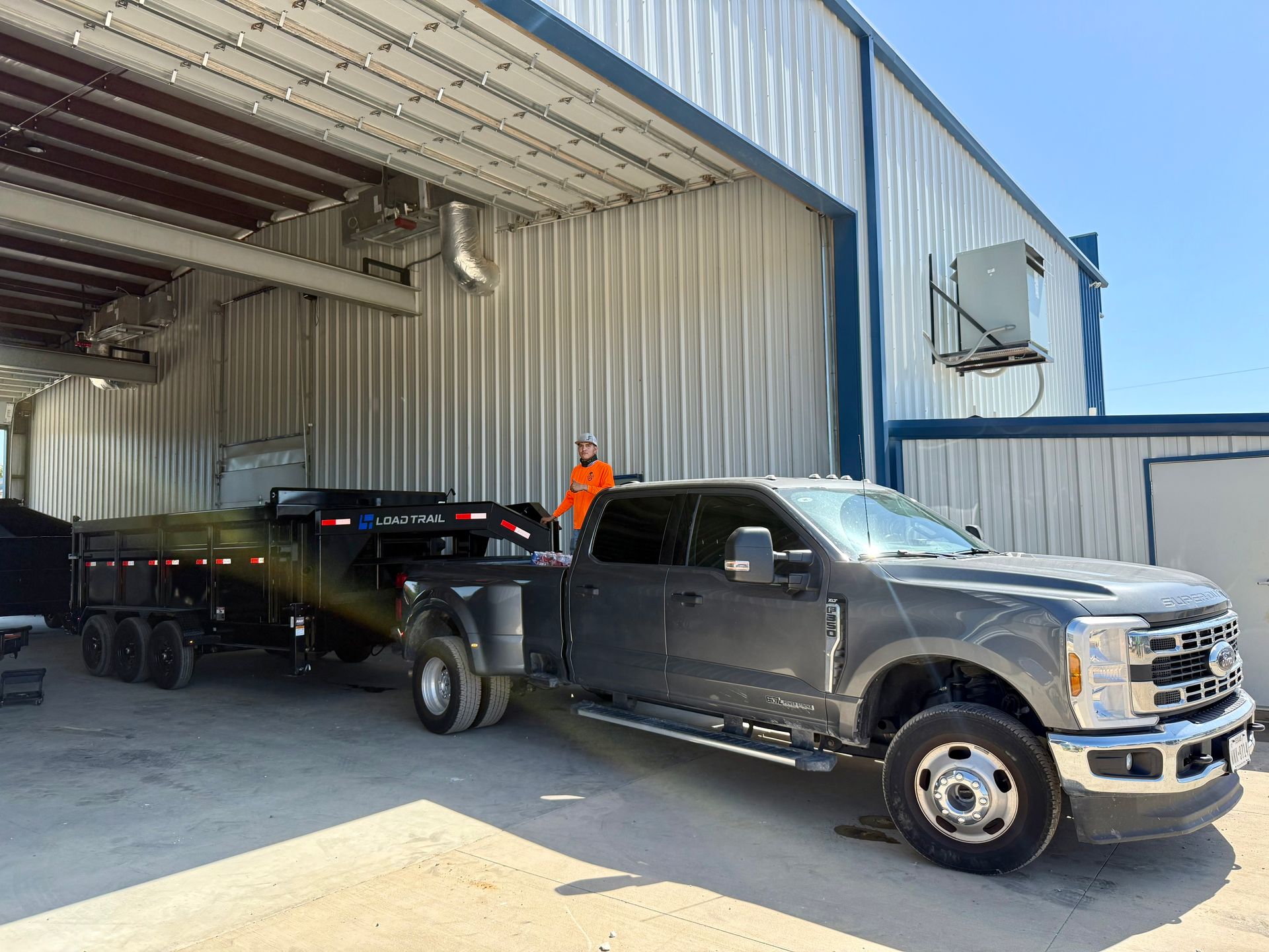A man is cutting a tree with a chainsaw.