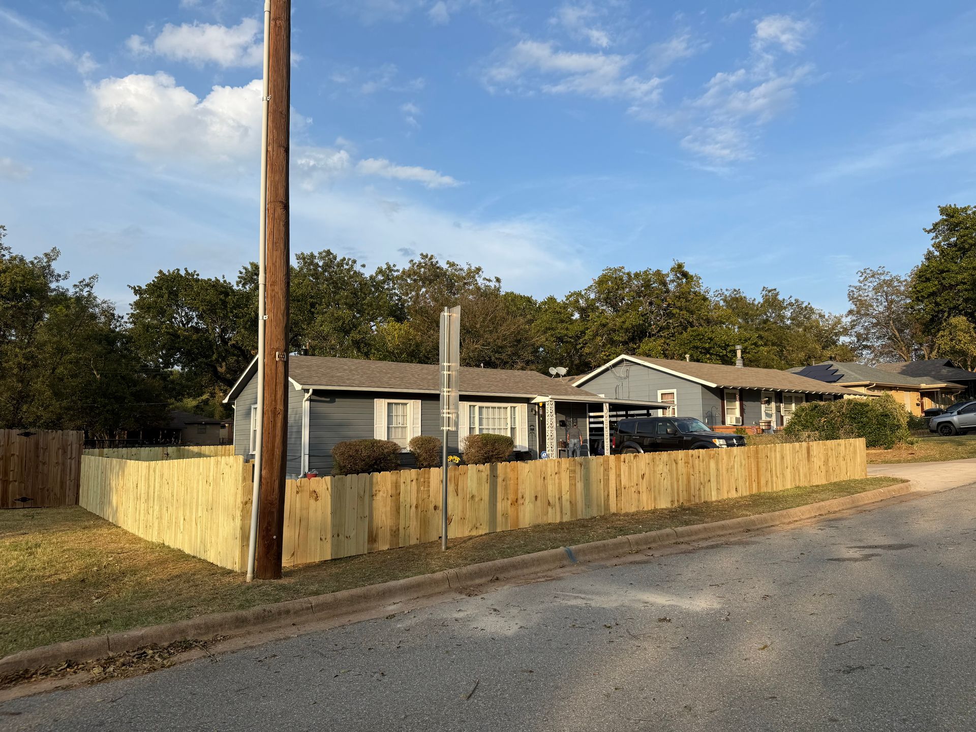 A man is cutting a tree with a chainsaw.