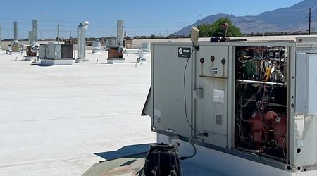A large gray box is sitting on top of a white roof.