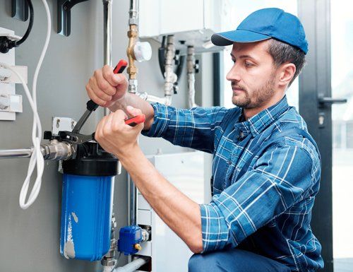 Young Plumber Repairing Water Filtration System — Wimauma, FL — Reedy Plumbing