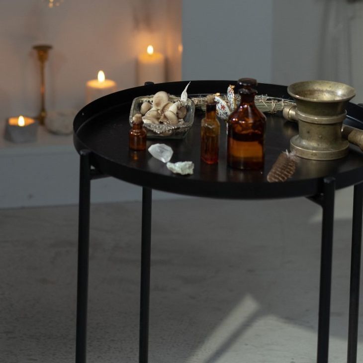 A table with bottles and candles on it