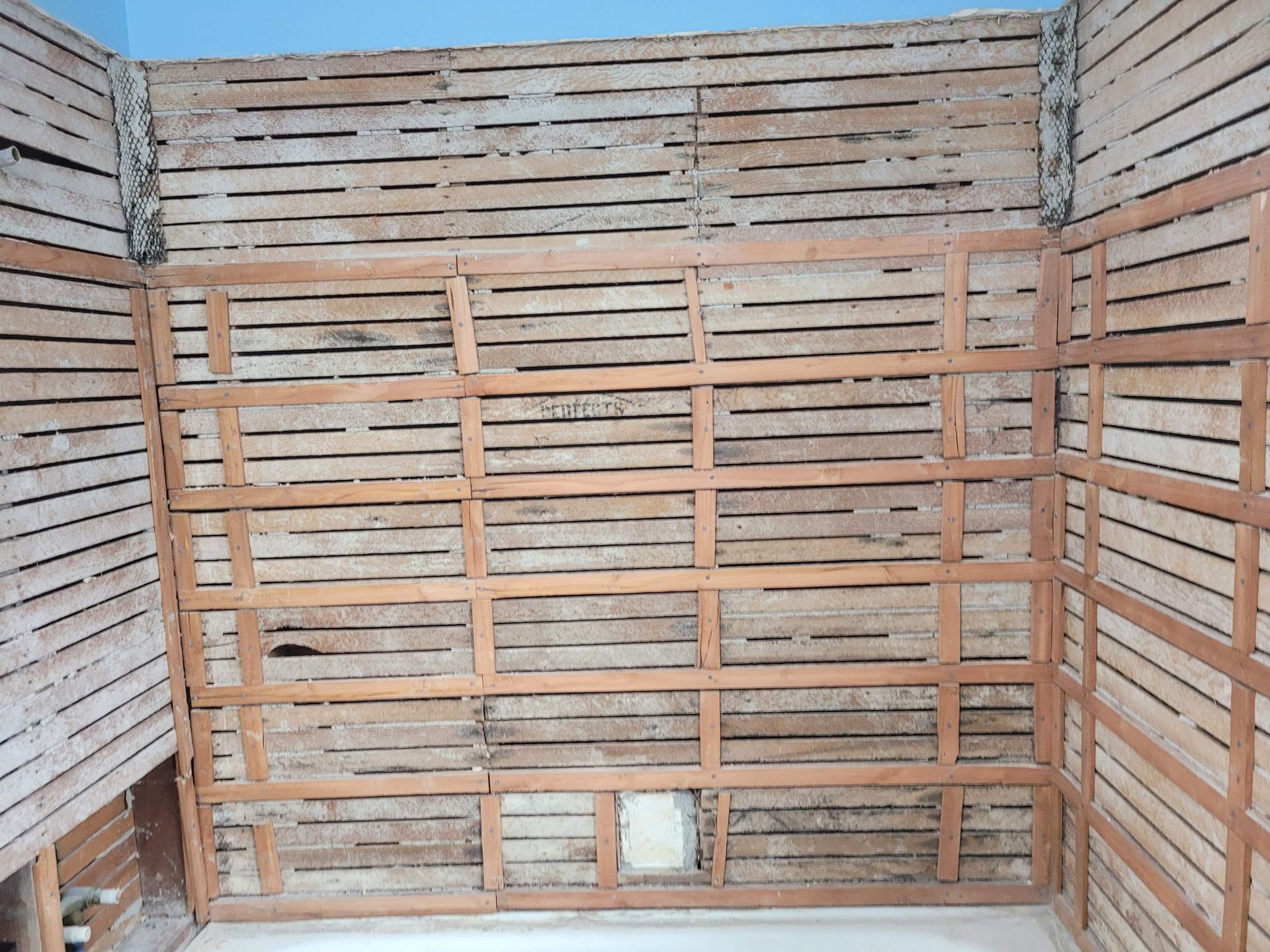 A room with a wooden wall and a white floor.