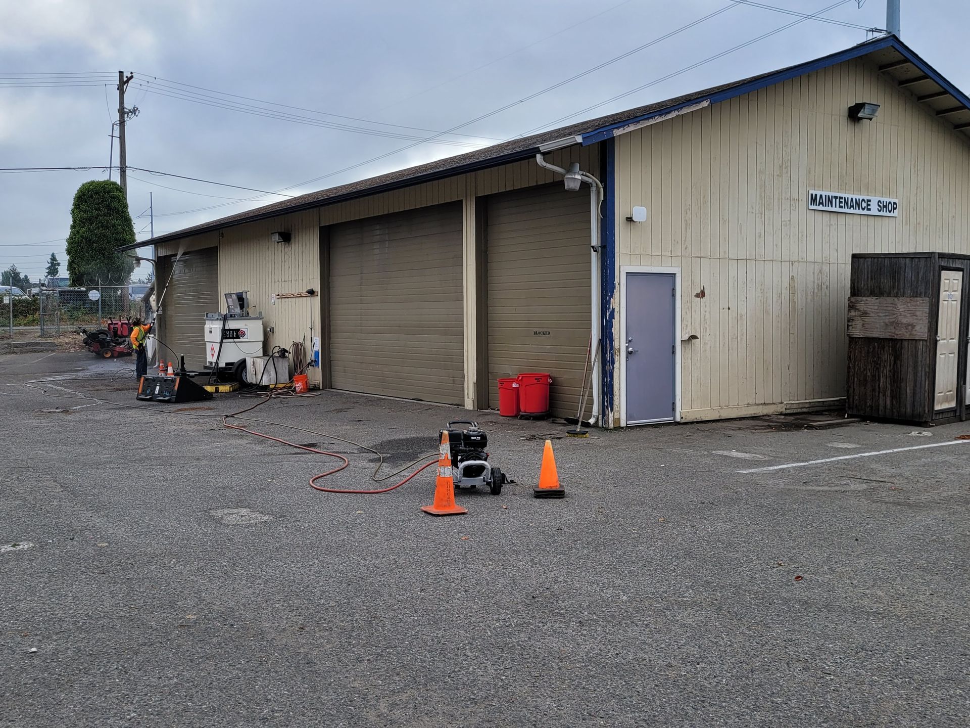 A large building with a lot of parking cones in front of it.