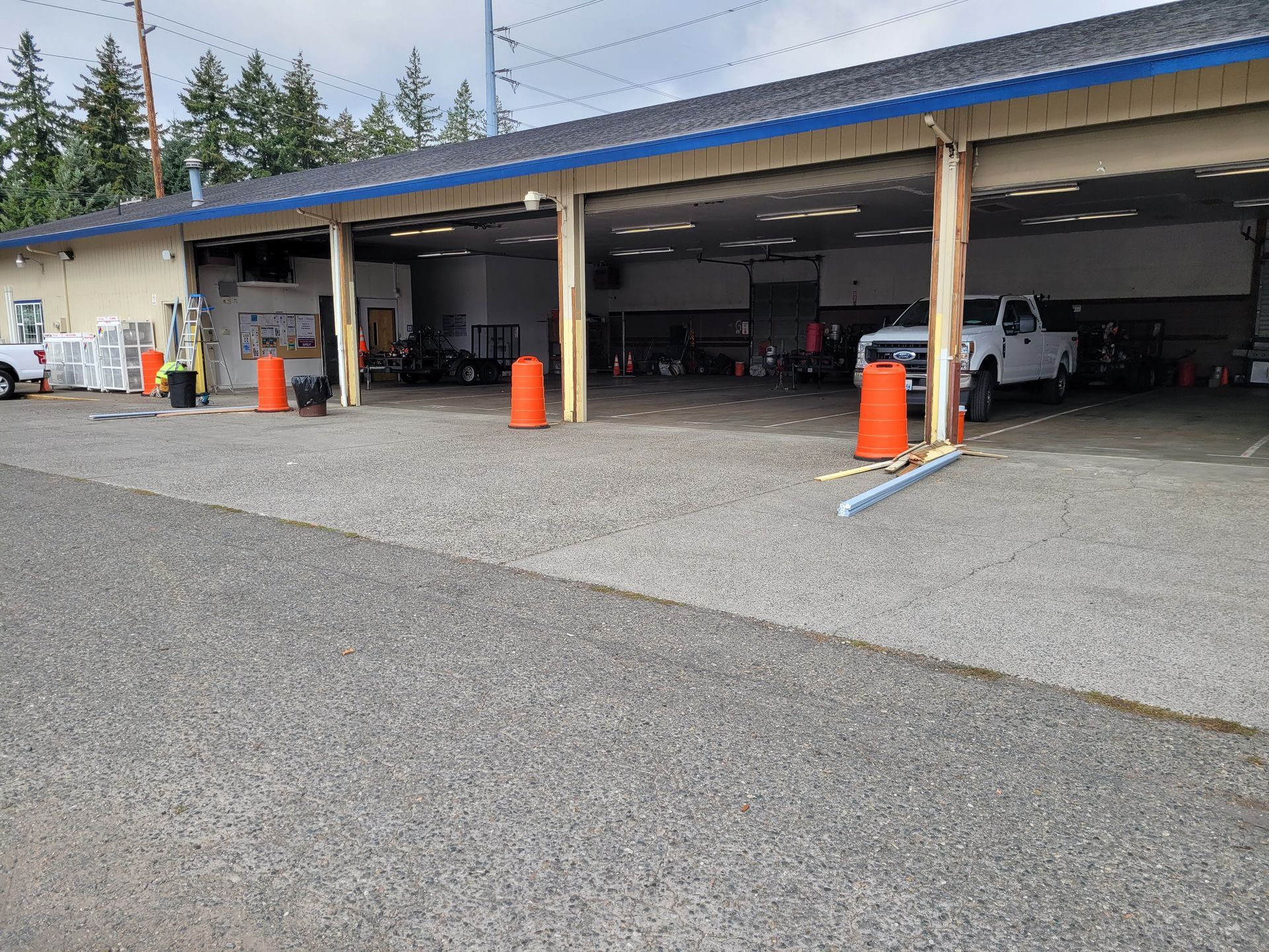 A white truck is parked in front of a garage.
