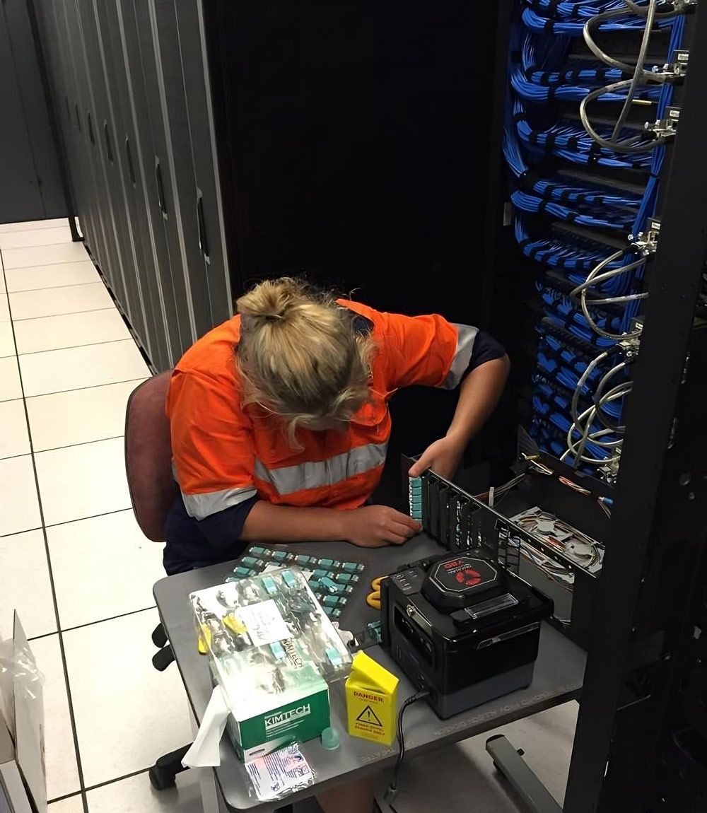 Woman Surrounded By Network Cabling Equipment