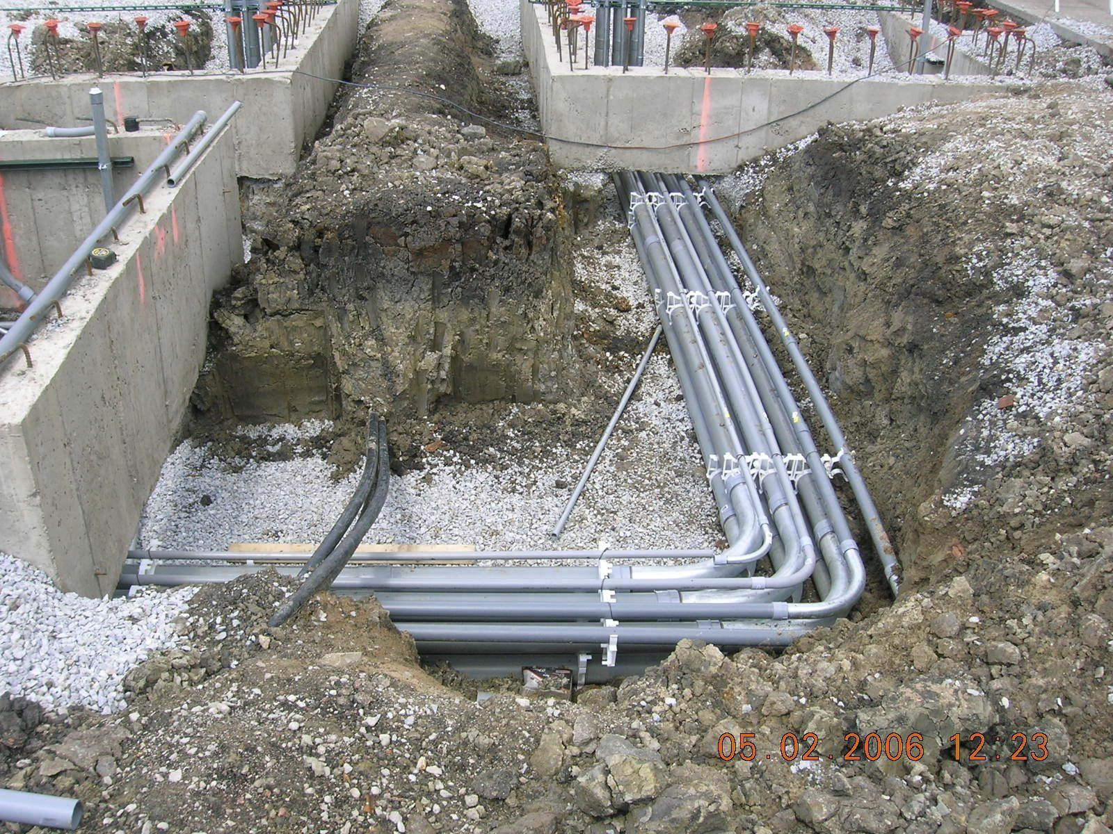 A bunch of pipes are being installed in a hole in the ground.