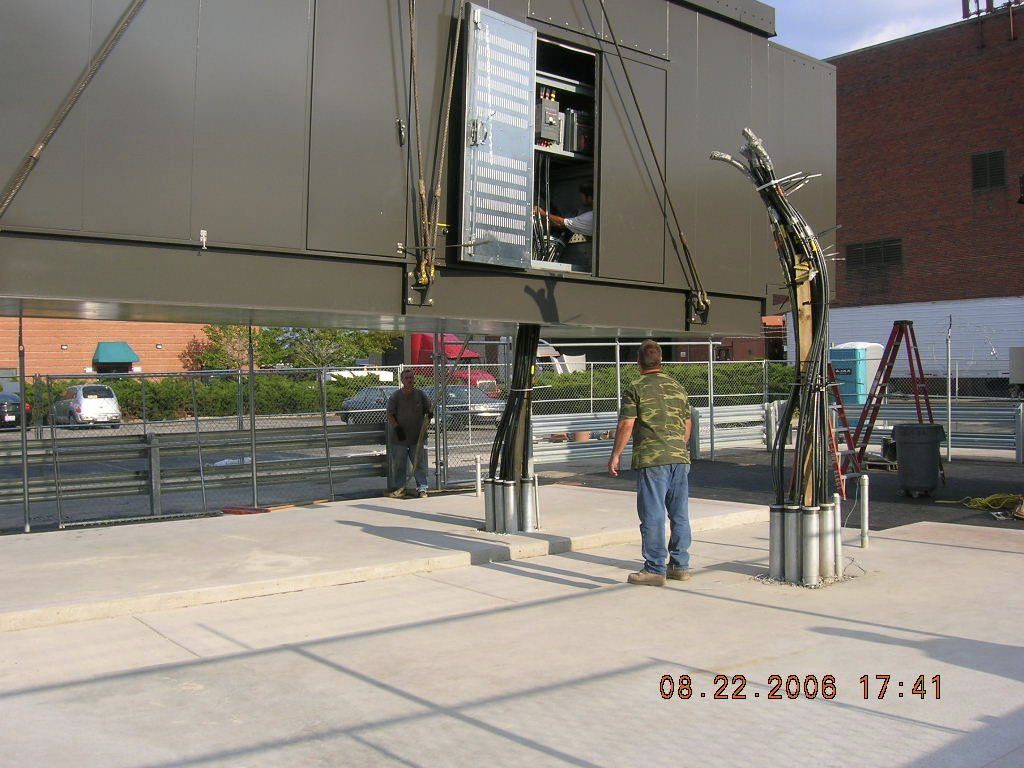 A man standing in front of a building with the date 08-22-2008
