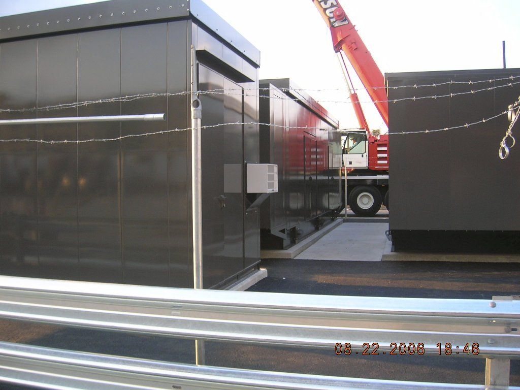 A red crane is being used to lift a container