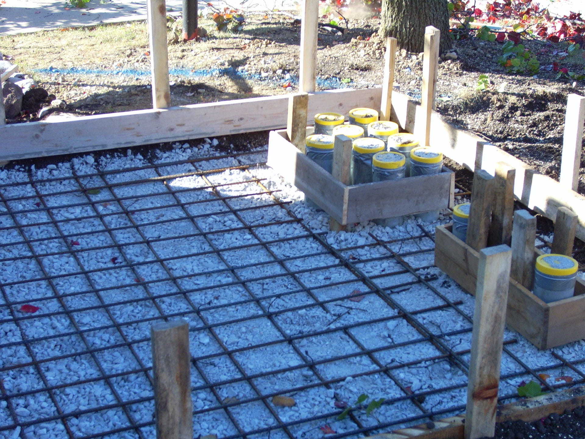 A bunch of containers are sitting on a concrete floor