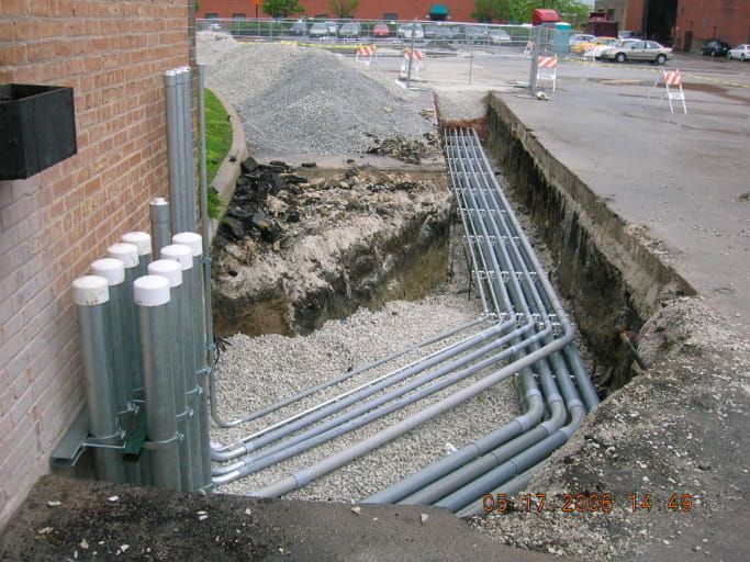 A bunch of pipes are being installed in a hole