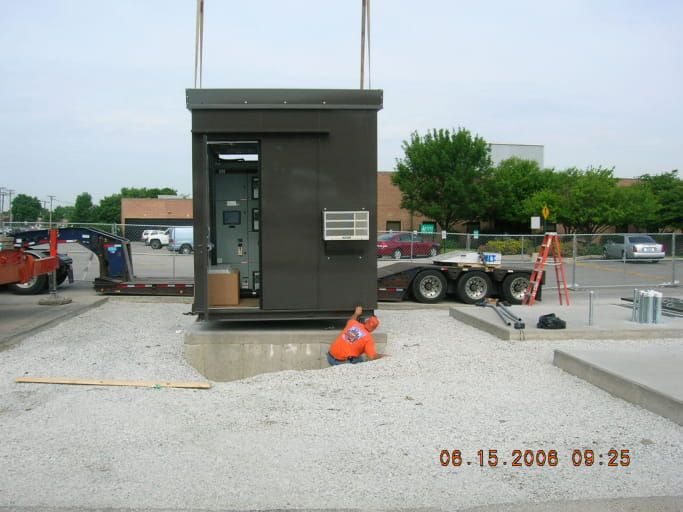 A man is laying on the ground in front of a building that is being built