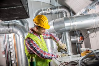 Engineer Checking Plans — HVAC Equipment in Bloomington, IL