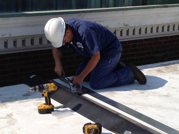 Worker installing HVAC platform — HVAC Equipment in Bloomington, IL