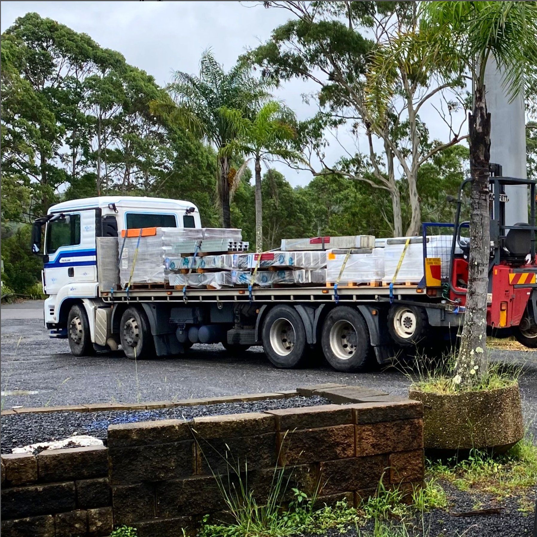 Flatbed Truck Loaded With Construction Materials — Concrete Sleepers NSW in Sancrox, NSW