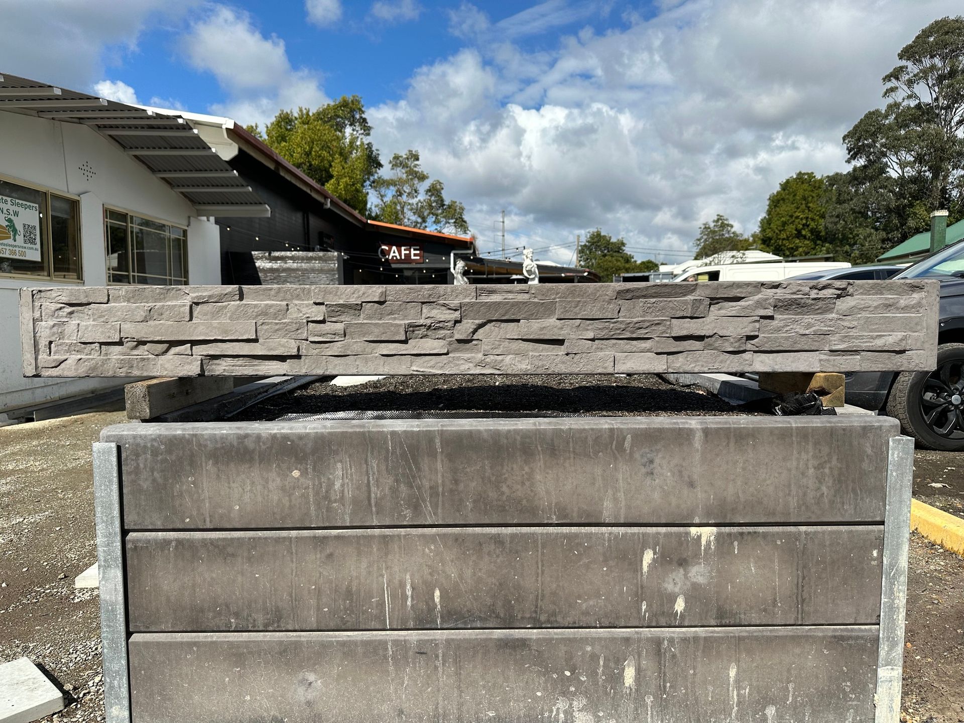 Stone-textured Ledge on a Concrete Block Outdoors, in Front of a Building — Concrete Sleepers NSW in Sancrox, NSW