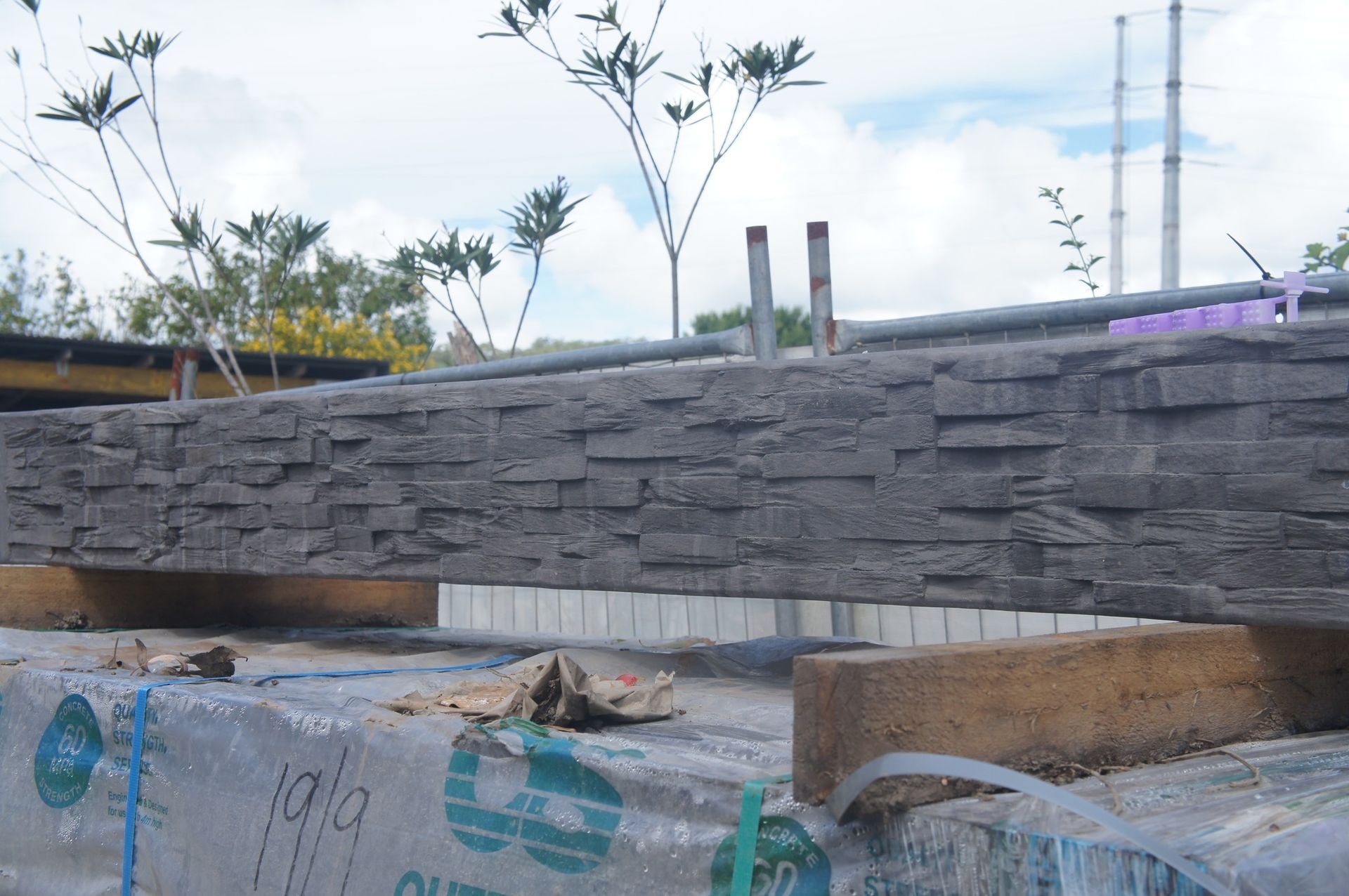 Construction Site With Gray Stacked Stone Wall, White and Brown Details — Concrete Sleepers NSW in Sancrox, NSW