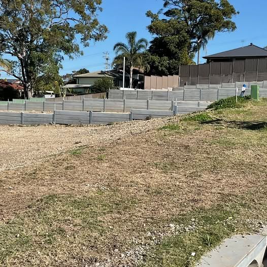Grassy, Tiered Construction Site With Retaining Walls — Concrete Sleepers NSW in Sancrox, NSW