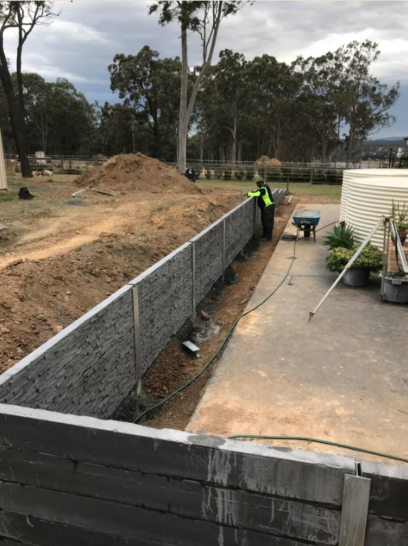 Construction Site: Worker Near a Long Concrete Wall — Concrete Sleepers NSW in Sancrox, NSW