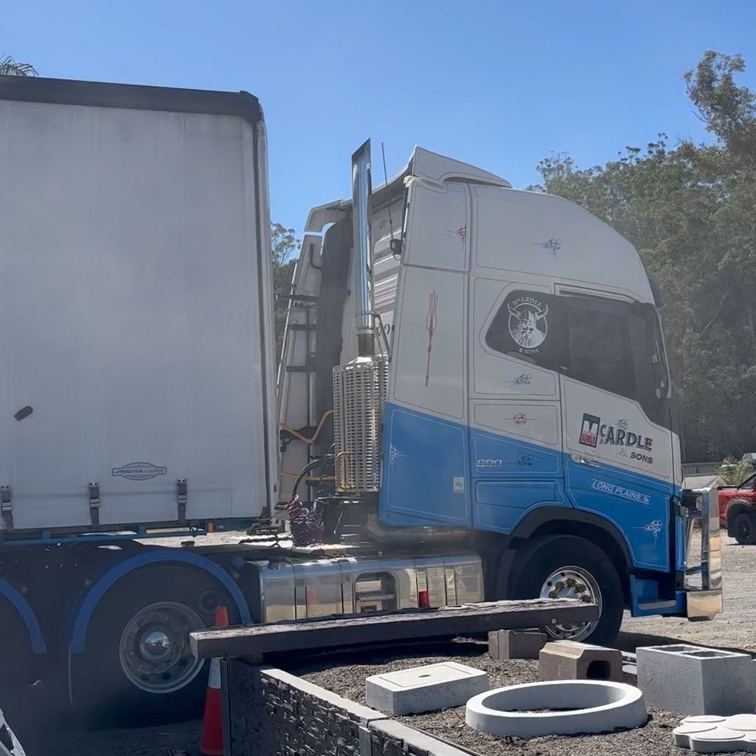 A blue and White Semi-truck Parked Outside With Its Trailer Attached — Concrete Sleepers NSW in Singleton, NSW