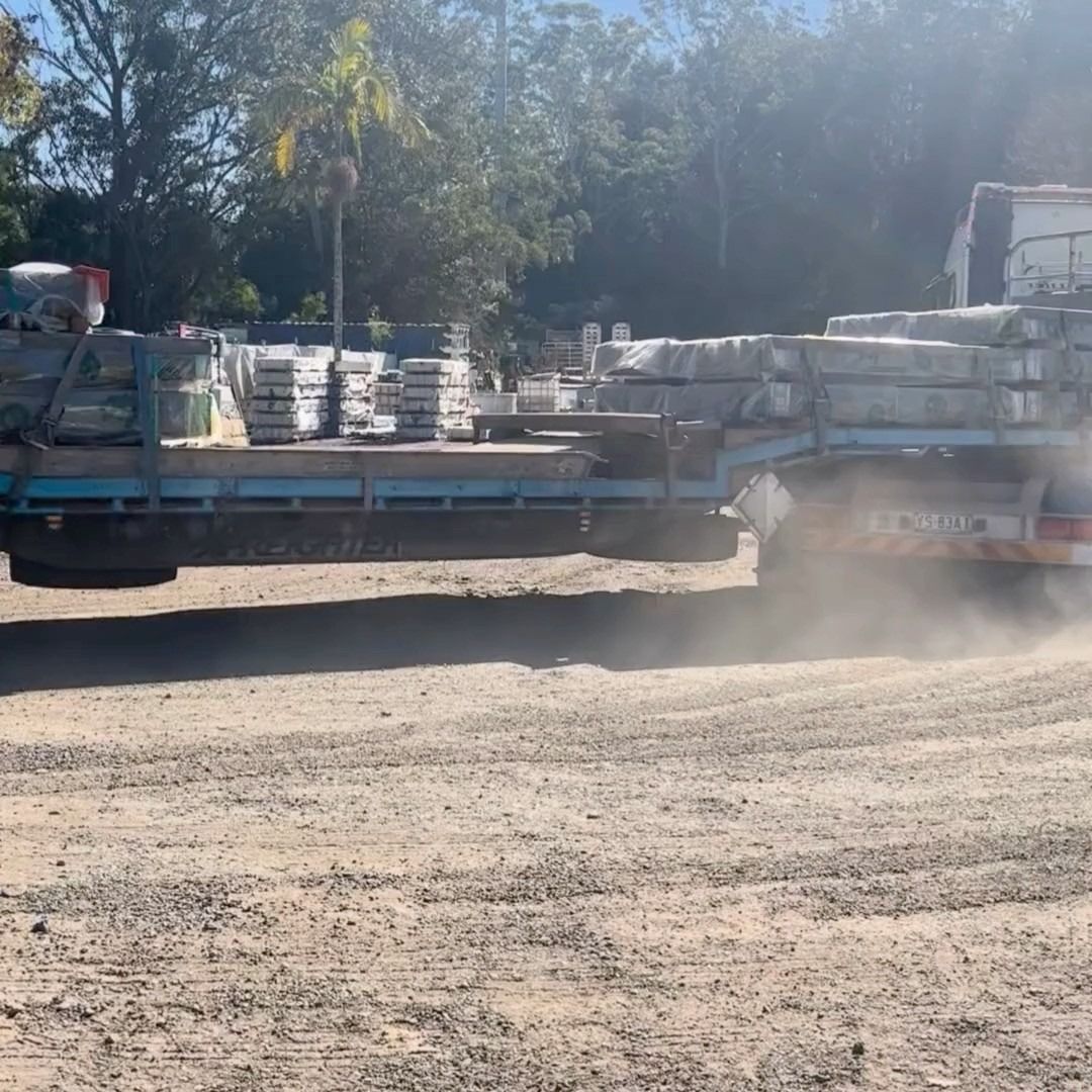 Truck Carrying Stacks of Stone Pavers on a Dirt Road — Concrete Sleepers NSW in Singleton, NSW