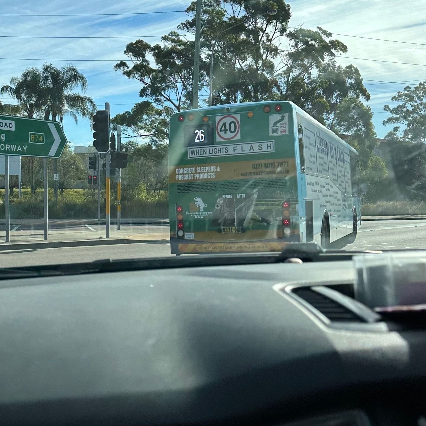 Green Bus at a Crossroad, Showing a Speed Limit of 40 Km/h — Concrete Sleepers NSW in Sancrox, NSW