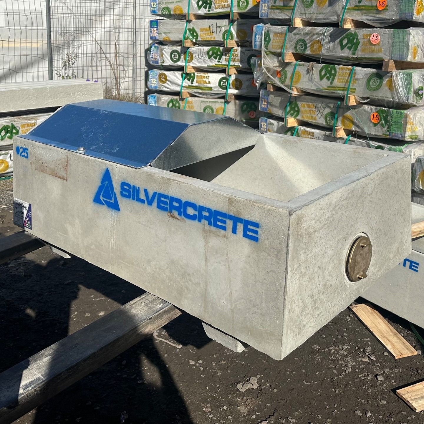 Concrete Trough With Angled Metal Top, Silvercrete Logo, Outdoors — Concrete Sleepers NSW in Sancrox, NSW