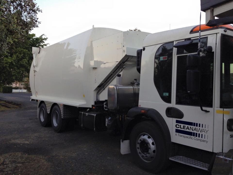 A Cleanaway Garbage Truck Is Parked On The Side Of The Road — Staunch Window Tinting In South Lismore, NSW