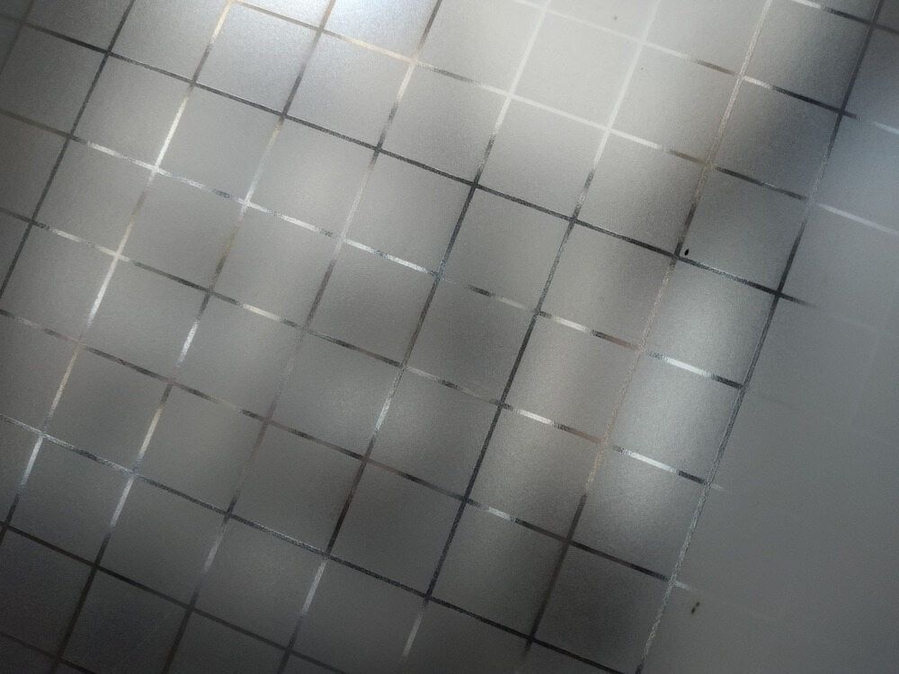 A Close Up Of A Gray Tile Floor With A Grid Pattern — Staunch Window Tinting In Kyogle, NSW