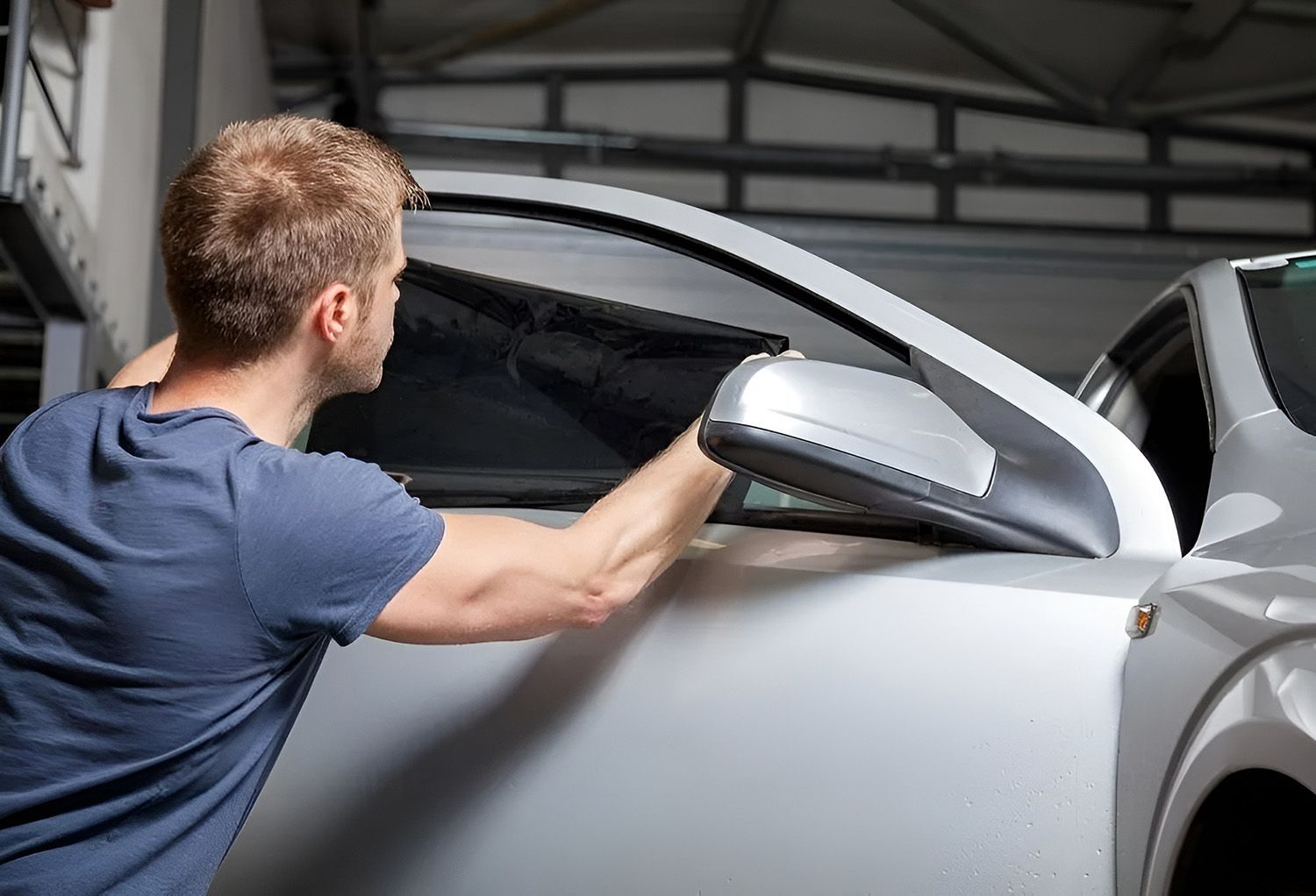 Man Applying Window Tint to a Car Door