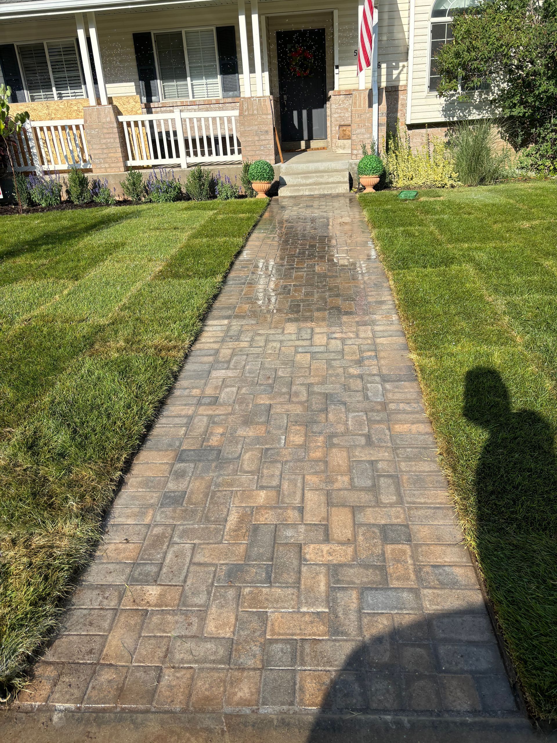 Judd Landscape & Curbing LLC | a brick walkway leading to the front door of a house.